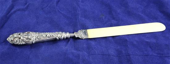 A late Victorian repousse silver handled ivory letter opener,